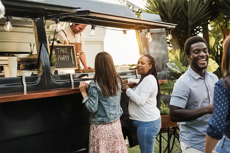 Selling Your Book While Standing in Line Two women chatting in line while ordering at a food truck