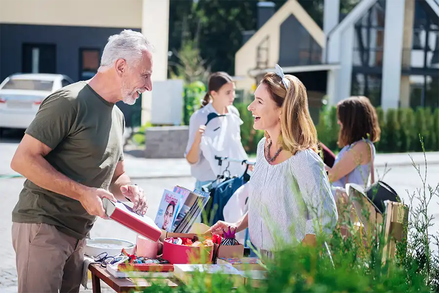 How to Get Local Media Coverage for Your Book Release A man and women discussing a book during a small outdoor event