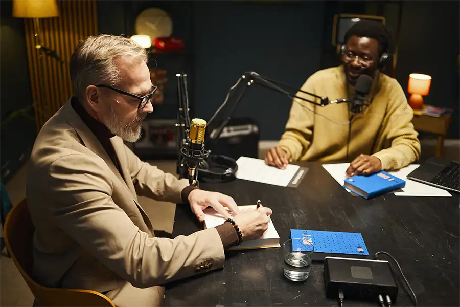 Unlocking the Power of Repurposing older male author signing his book during an interview